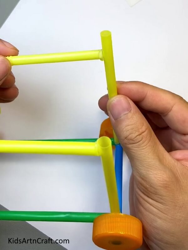 Pasting The Yellow Straws To Each Other-Making a Toy Car with Straws - Instructions for Children