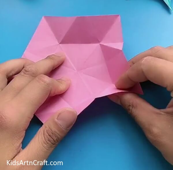 Folding Paper Along Small Pentagon Creases-Instructions on creating a Star Flower with the art of Origami, designed for children