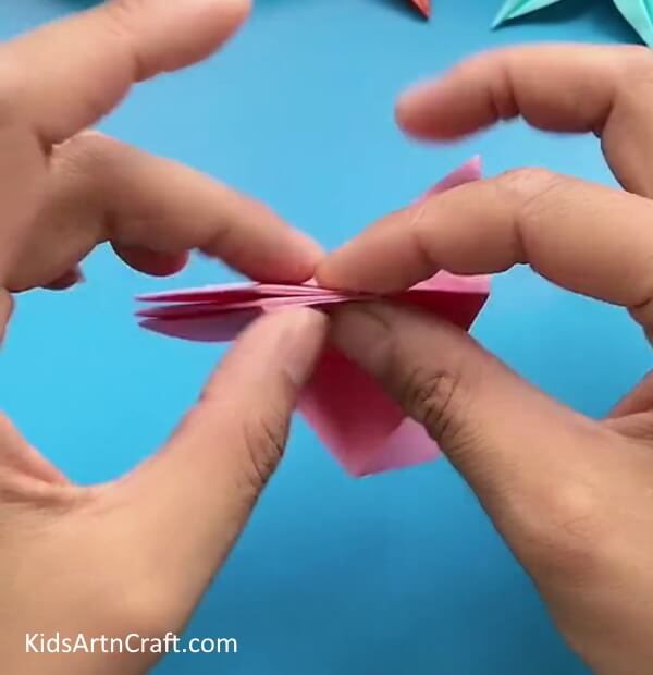 Folding Next Flap Along With The First Flap-This tutorial is tailored for children and provides a straightforward path to making an Origami Star Flower