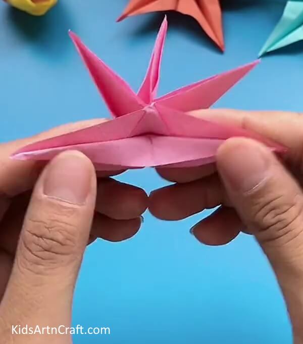 Folding Paper To Form a 'V' Shape On Top-This guide will teach you how to make an origami craft with a simplified approach for kids
