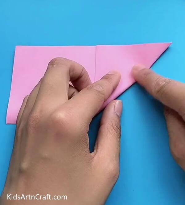 Folding Bottom Right Corner To Form A Triangle-Learn how to fashion a Star Flower with ease through this tutorial designed for children