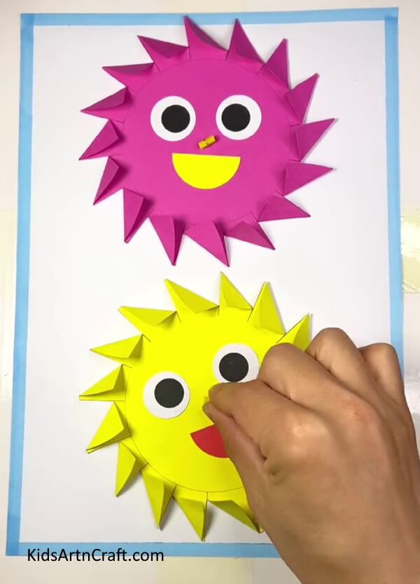 Inserting Sun's Nose In Hole- Crafting a Paper Sun Toy with the Use of Blowing