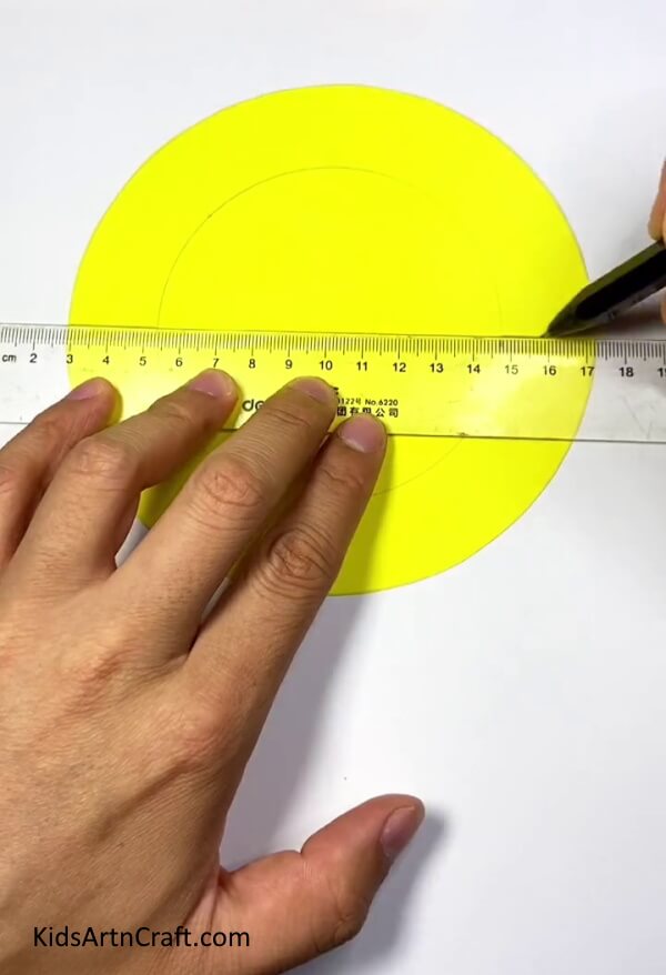 Drawing Lines On Outer Ring-Guide to making a paper sun toy that kids can blow