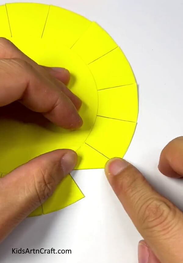 Folding Cuts In Right Direction-Showing how to make a paper sun plaything that children can puff on