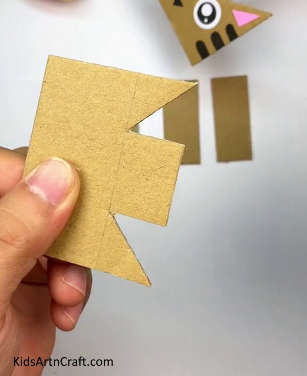 Cutting Out The Triangles-Kids can construct a Cardboard Cat with this simplified tutorial