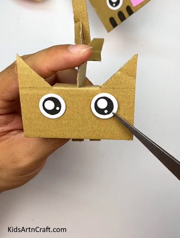 Making The Eyes And Tail Of The Cat-Kids can effortlessly make a Cardboard Cat with this straightforward tutorial 