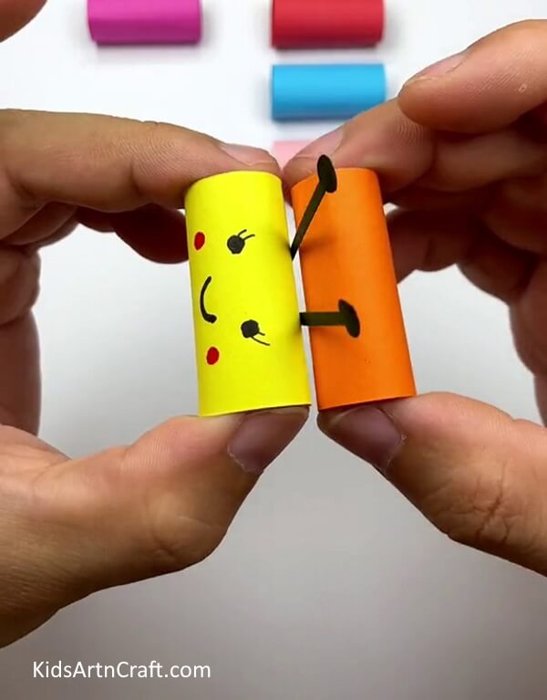 Stick Different colored paper roll to make the body - Arranging a Colorful Paper Caterpillar On a Leaflet