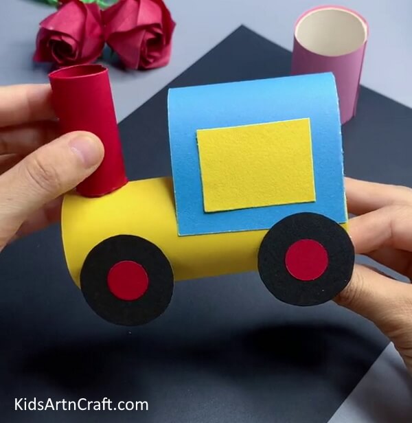 Pasting The Cylinder Over The Yellow Roll - Kids can have a blast creating a paper train craft