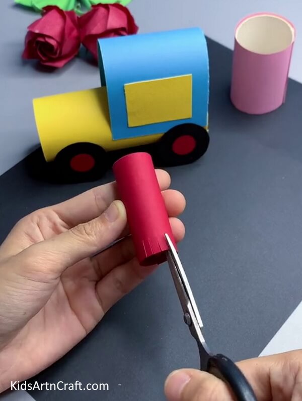 Cutting Strips From The End Of Red Cylinder - A fun paper train craft activity for kids
