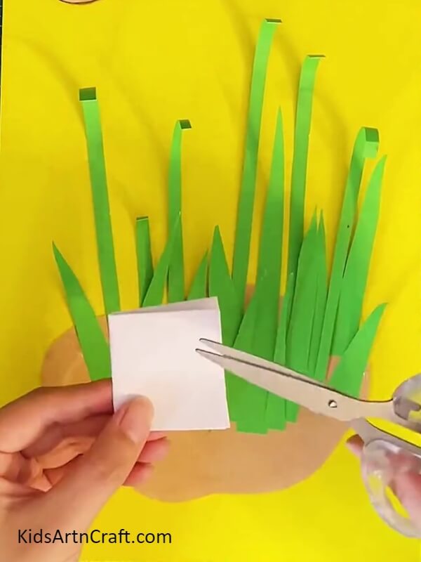 Cutting Pale Pink Color Craft Paper To Make A Flower-Assembling a Paper Lily Flower Work For Children