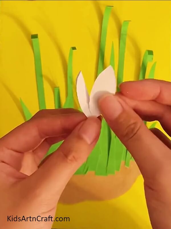 Cutting Lily Petals From Pieces Of Pale Pink Squares-Putting Together a Lily Paper Floral Craft For Kids