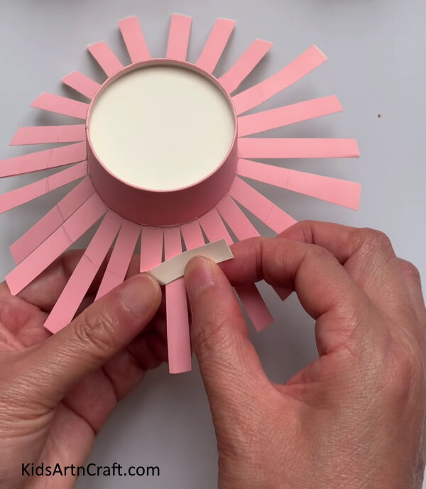 Twisting A Paper Strip - Assembling mini hats from paper cups for kids 