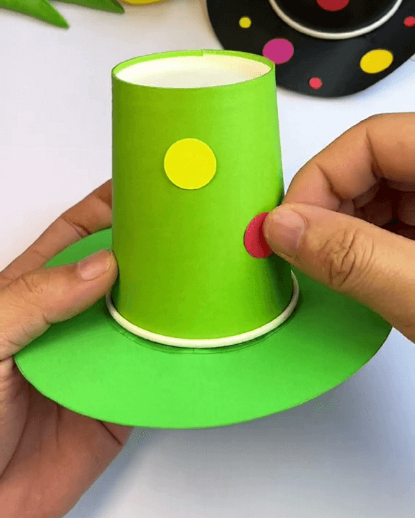 Decorating The Paper Cup Hat With Some Circular Colourful Papers-Mini Paper Cup Hat For School Craft
