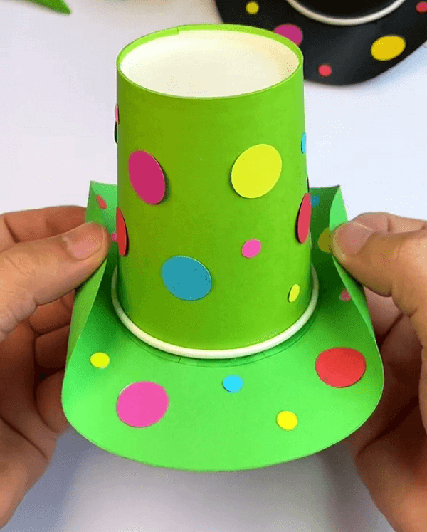 Turning The Paper To Give It  Shape Like A Hat-Small Hat Design Using Paper Cup