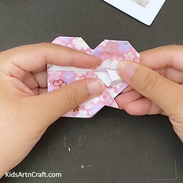 Working On The Triangles In The Middle- The steps to making an Origami Heart Envelope are outlined in this tutorial. 