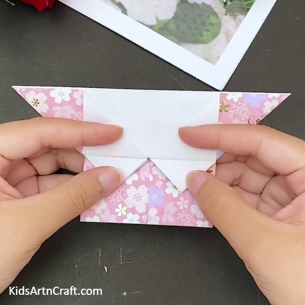 Flattening The Triangular Folds Downwards- Mastering the art of origami to make a heart-shaped envelope 
