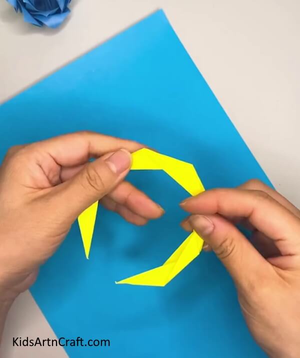 Pressing the Shape Down to Seal it- Crafting a Moon Out of Origami Step By Step 