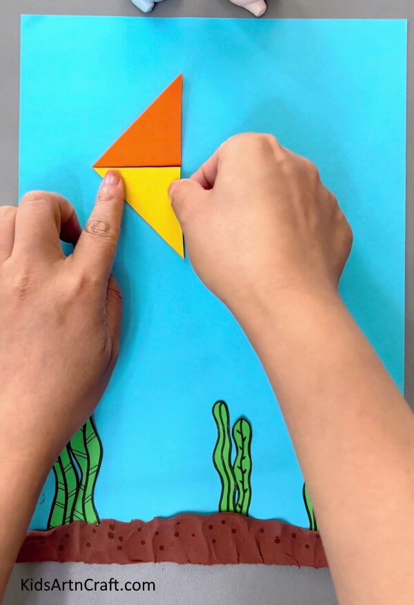 Pasting A Yellow Triangle-A simple origami fish tutorial for children