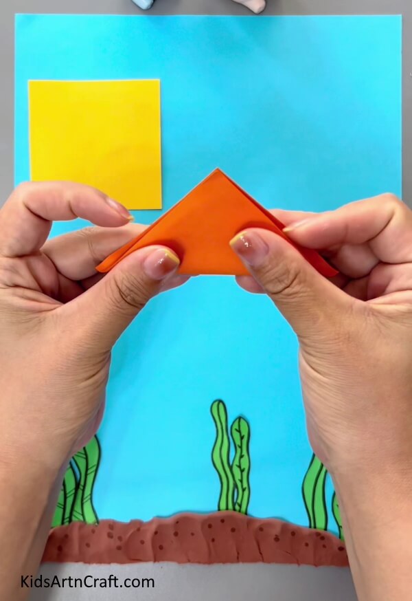 Folding A Paper Square-Creating origami fish - a tutorial for children
