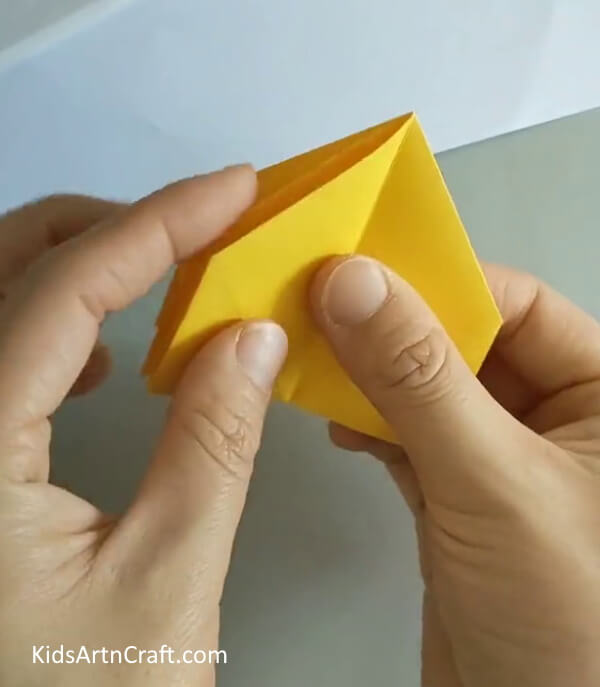 Fold the portion to the other side- A Simple Guide to Crafting an Origami Rose for Novices 