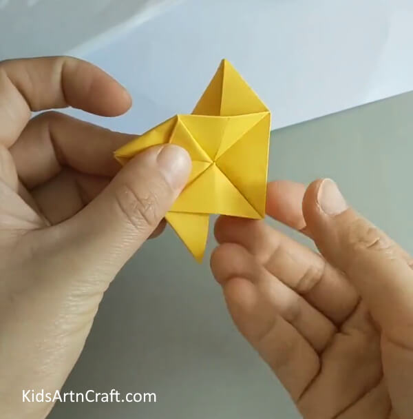 Bring the triangular folds in place- Crafting an Origami Rose - A Guide for Beginners 