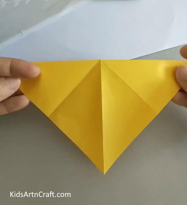 Fold the paper into two halves- A Guide to Creating a Rose out of Origami for Newbies