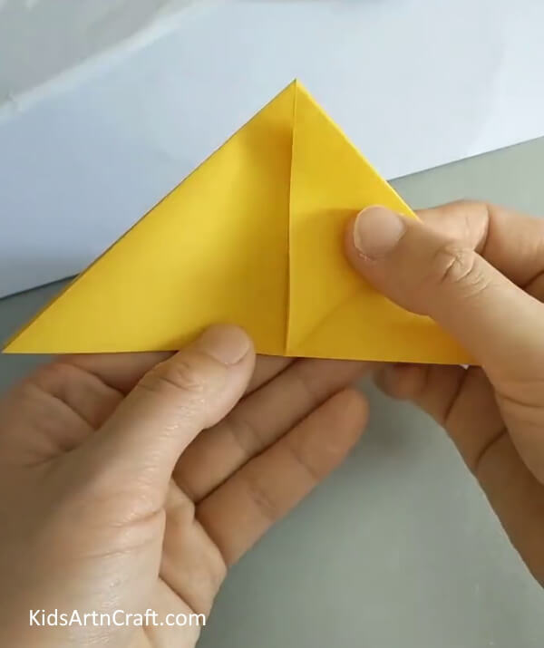 Take upper portion and fold it towards the left- Origami Rose Building Instructions for Novices