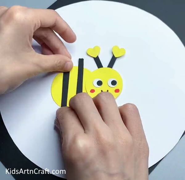 Adding The Black Strips-Assembling a Paper Bee Craft for Tots 