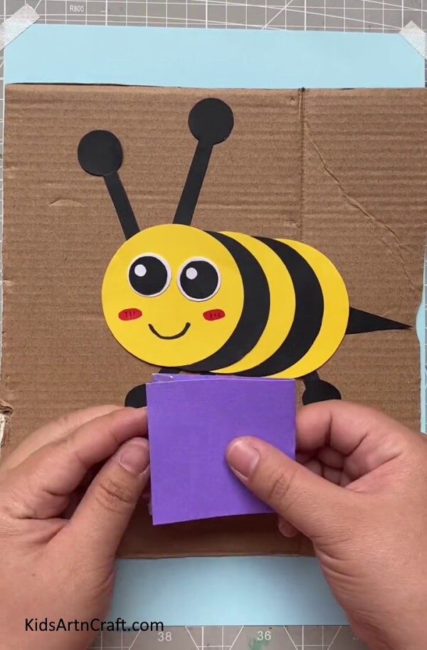 Folding it in Square with your hand To Make Paper Bee-Showing children how to make a Paper Bee craft 