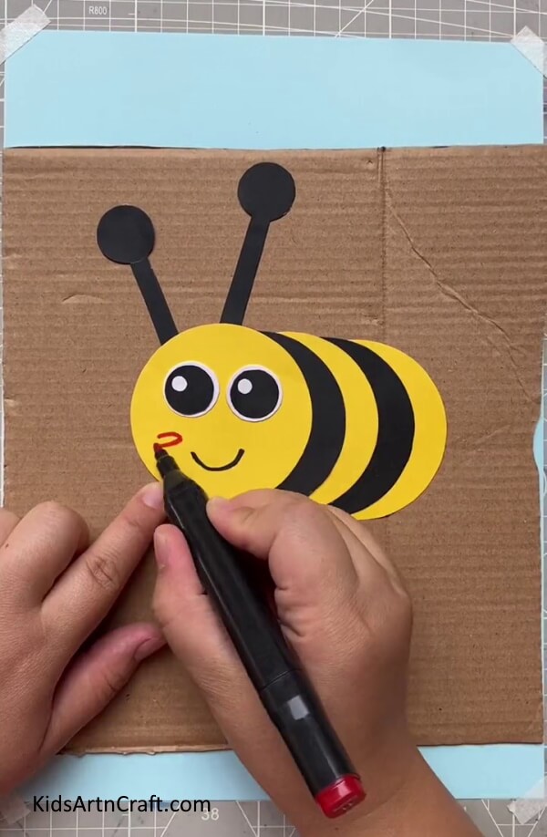 Adding a Smiley Face and Cheeks with sketchpen-Making a Paper Bee - a straightforward kids' craft 