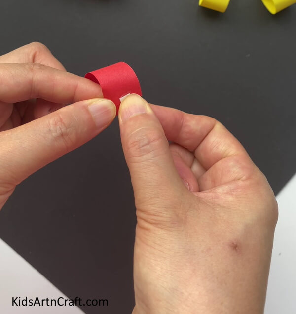 Applying Double Side Tape On The Ends An easy guide to making Paper cherries for children 