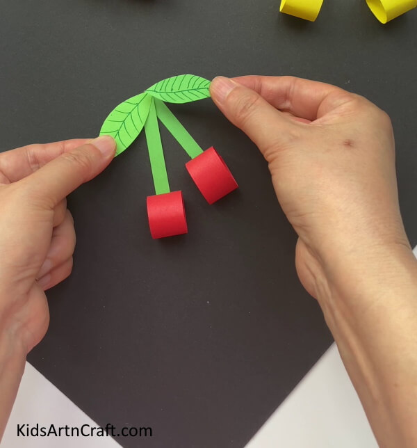 Adding Leaves To The Paper Cherry An uncomplicated tutorial for children to make Paper cherries 