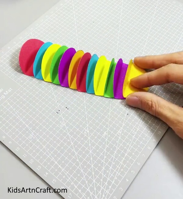 Adding More Circles - Making a Paper Circle Caterpillar Artwork For Children 