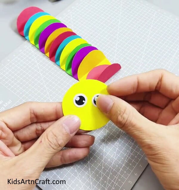 Adding Eyes To The Yellow Circle - Form a Circular Paper Caterpillar Craft For Little Ones 