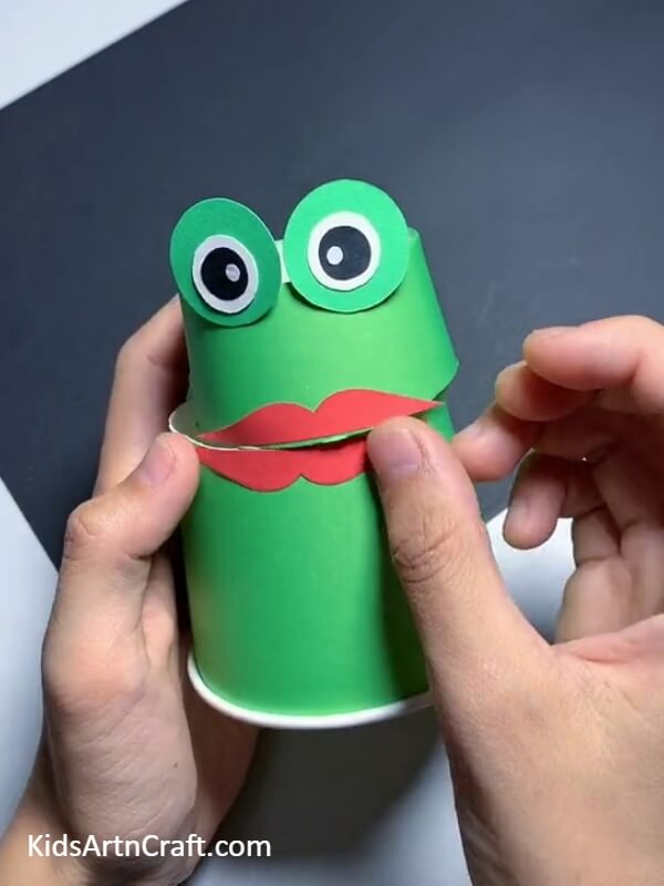 Pasting The Lower The Lip-A Guide to Crafting a Frog Puppet with a Paper Cup for Children