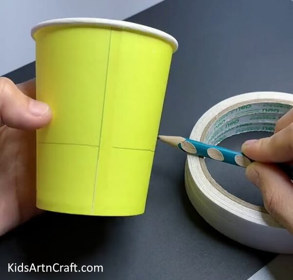 Drawing A '+' Over A Paper Cup - Utilize a Recycled Paper Cup for a Sunflower Art Project for Children 