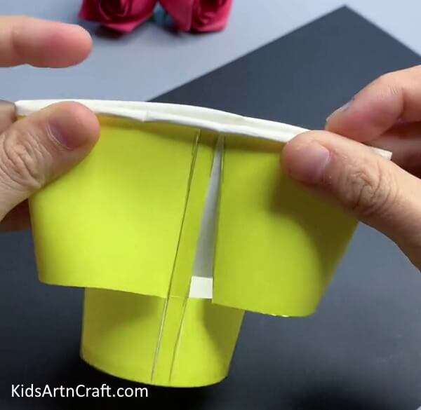 Cutting Out The Outline - Transform a Paper Cup into a Sunflower Craft for Youngsters 