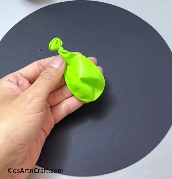 Tieing  A Knot Of A Balloon - Forming Paper Zombie Plants As A Pastime For The Young