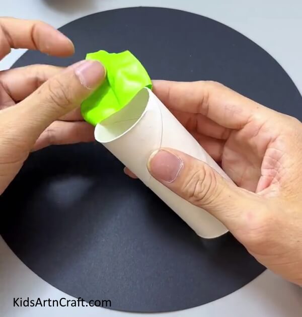 Putting The Balloon Over An Empty Toilet Paper Roll - Creating Paper Zombie Plant Projects For Kids