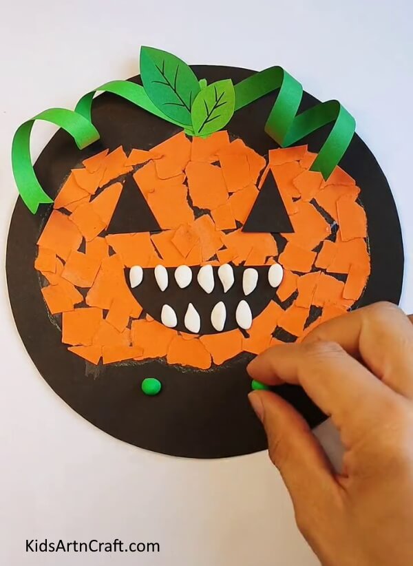 Making Tiny Balls Out of Clay and Stick them on the Rest of the Board - Step-by-Step Guide to Building a Paper Pumpkin