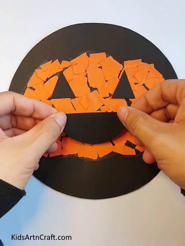 Sticking a Black Craft Paper as Mouth - Crafting a paper pumpkin - a tutorial