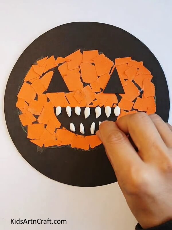 Gluing Some Clay As Teeth - A tutorial on making a paper pumpkin