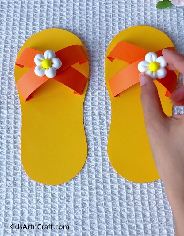 Adding on the flower charms- Making Paper Slippers - A Step-by-Step Guide for Youngsters