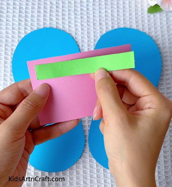 Making the slipper strap on pink craft paper- Crafting Paper Slippers - A Step-by-Step Guide for Kids