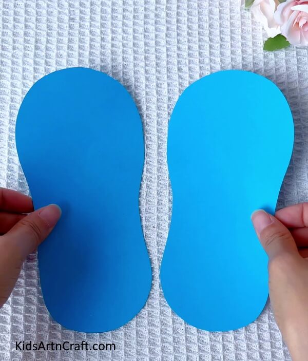 Starting the first slipper with Blue Craft Paper- Guidelines for Crafting Paper Slippers - A Step-by-Step Guide for Children