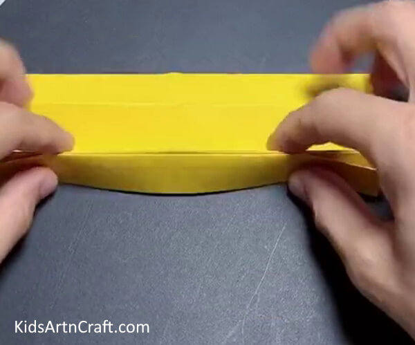Taking Yellow Craft Paper and Fold It - Constructing a Paper Sunflower Craft for youngsters