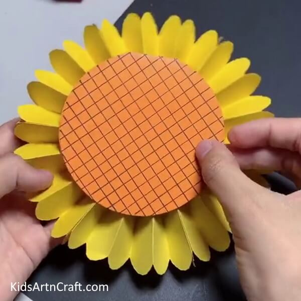 Sticking the Orange Circle on the Yellow Craft Paper with Glue - Art project for kids - creating a Paper Sunflower