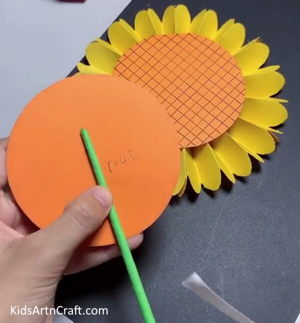 Sticking the Green Stem on Orange Craft Paper - Making a Paper Sunflower for young ones