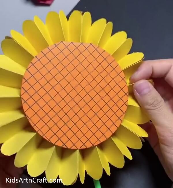 Sticking the Stem Behind the Sunflower - Construct a Paper Sunflower with children