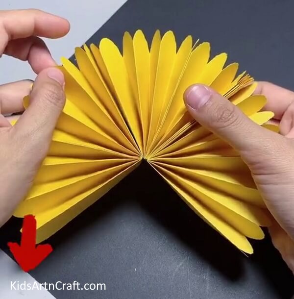 Sticking Another Petal on the Left Side - Constructing a Paper Sunflower Assignment for children